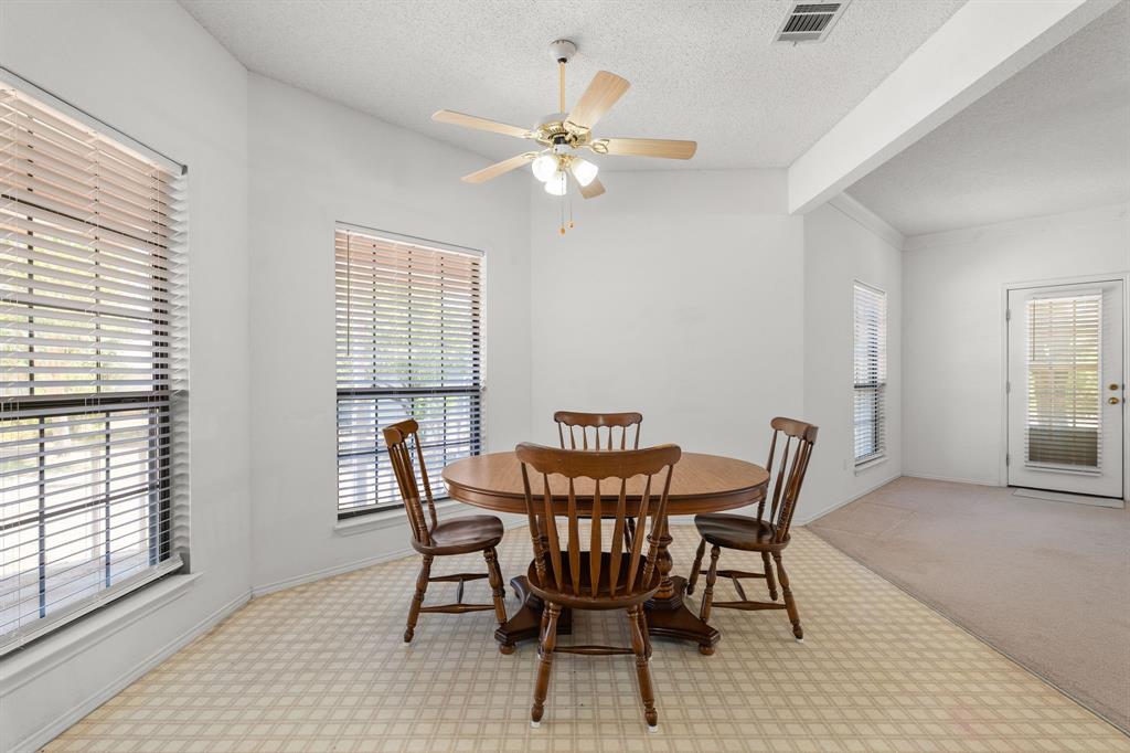 162 Warren Road Lorena, TX 76655 - Photo 14 of 39 Vaulted ceiling with a ceiling fan, multiple windows with blinds, patterned flooring, and a glass-paneled door