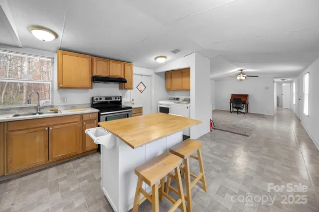 a kitchen with a sink stove and cabinets