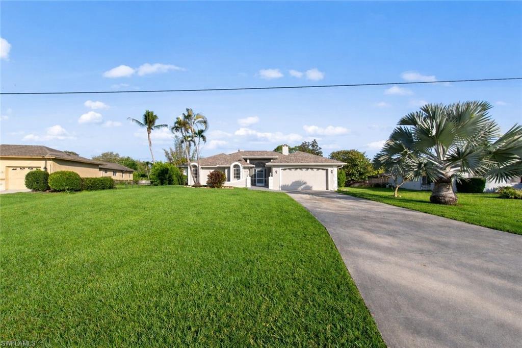 4724 Riverside Drive Estero, FL 33928 - Photo 2 of 44 a house view with a garden space