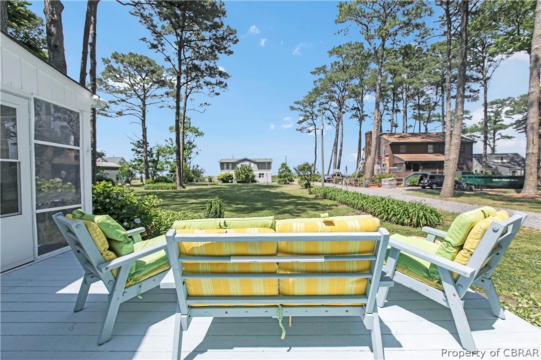 175 Seaside Way Gwynn, VA 23076 - Photo 9 of 48 a view of a chairs and tables in the backyard of a house
