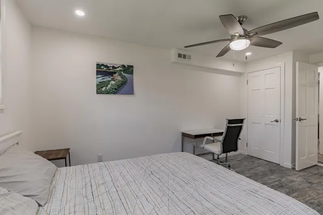 a bedroom with a bed and a chandelier