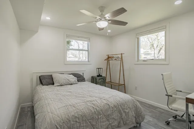 a bedroom with a bed and a window
