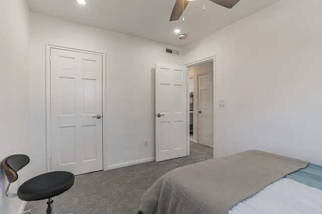 a bedroom with a bed a lamp and a window