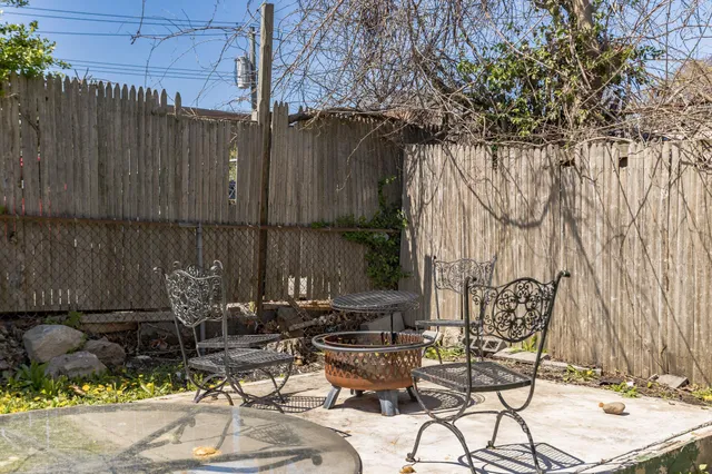 a view of backyard with outdoor seating and plants