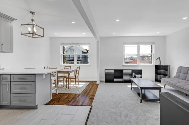 a living room with furniture a piano and a flat screen tv