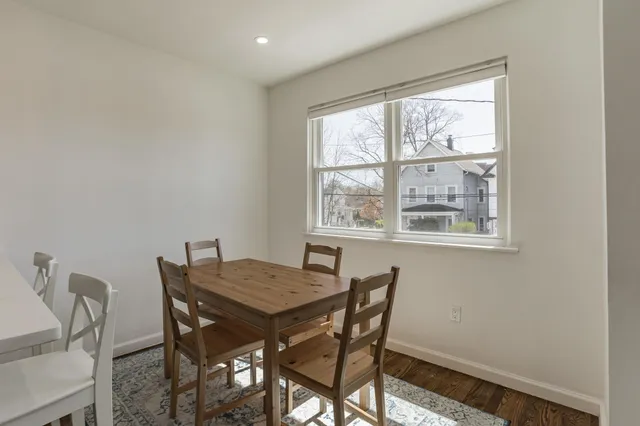 a view of a dining room with furniture and window