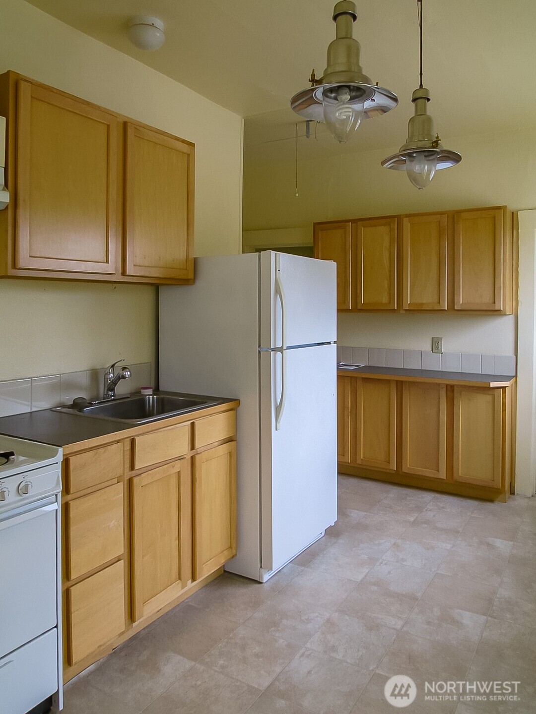 3823 Delridge Way Southwest Seattle, WA 98106 - Photo 14 of 18 a kitchen with cabinets a sink and appliances
