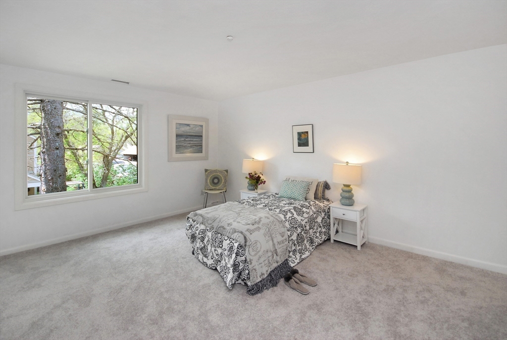 18 Concord Greene, Unit 6 Concord, MA 01742 - Photo 14 of 24 a bedroom with a bed and a window