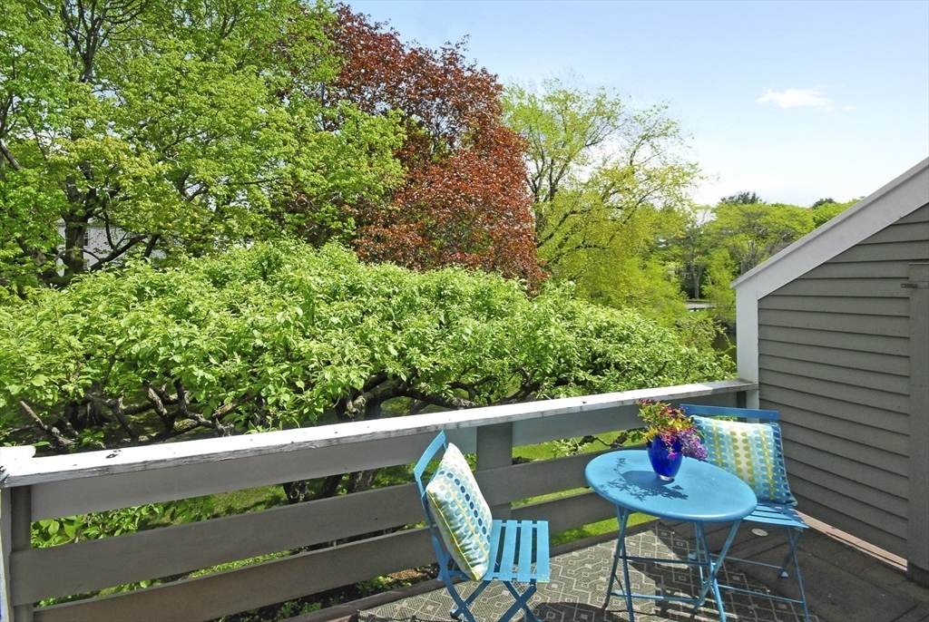18 Concord Greene, Unit 6 Concord, MA 01742 - Photo 20 of 24 a balcony with wooden floor and outdoor seating