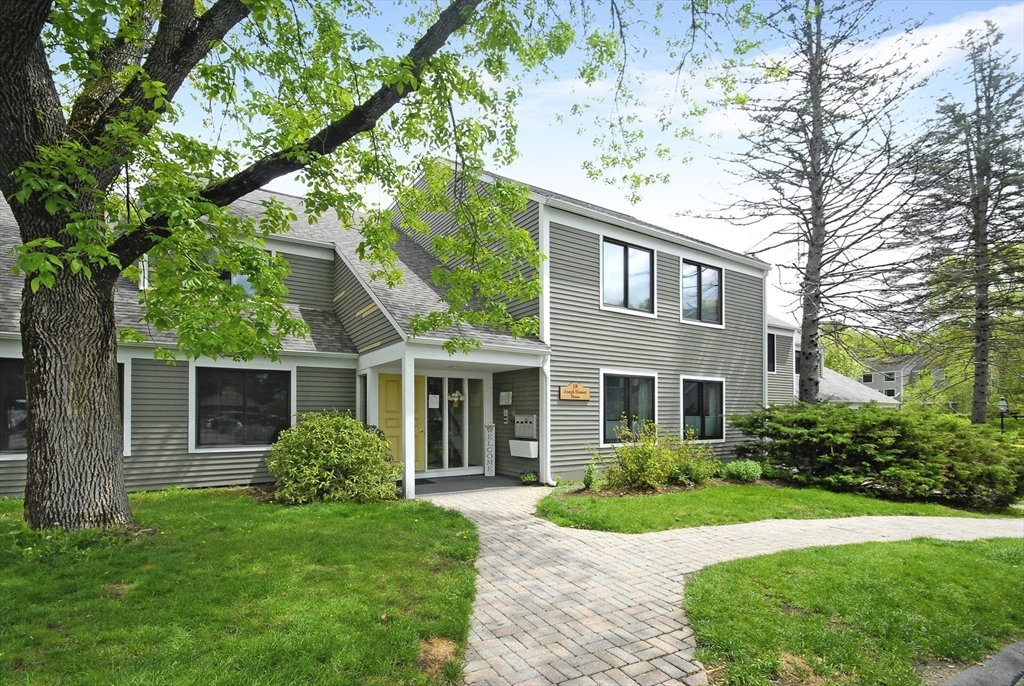 18 Concord Greene, Unit 6 Concord, MA 01742 - Photo 21 of 24 a front view of a house with a yard and green space