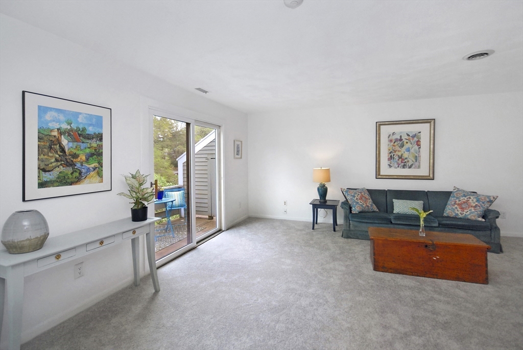 18 Concord Greene, Unit 6 Concord, MA 01742 - Photo 4 of 24 a living room with furniture and a flat screen tv