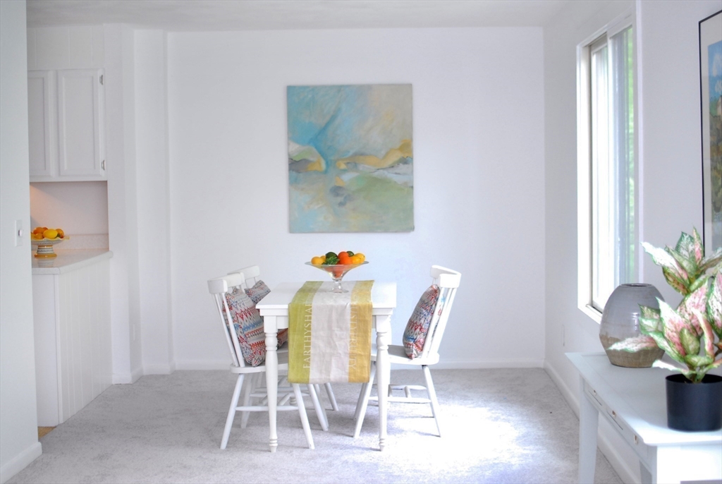 18 Concord Greene, Unit 6 Concord, MA 01742 - Photo 5 of 24 a dining room with furniture and potted plants