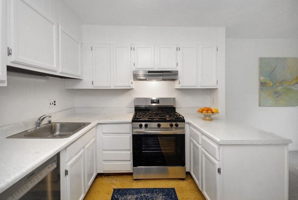 18 Concord Greene, Unit 6 Concord, MA 01742 - Photo 10 of 24 a kitchen with white cabinets and appliances