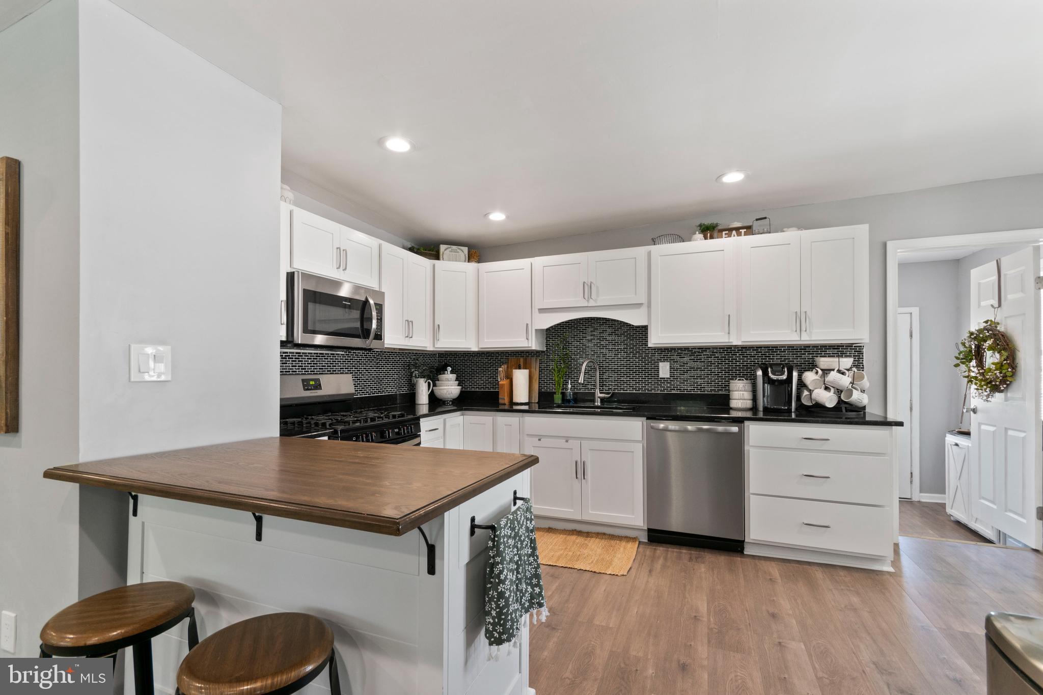 1 West Post Road Morrisville, PA 19067 - Photo 5 of 16 a kitchen with stainless steel appliances a stove top oven a sink dishwasher and a microwave