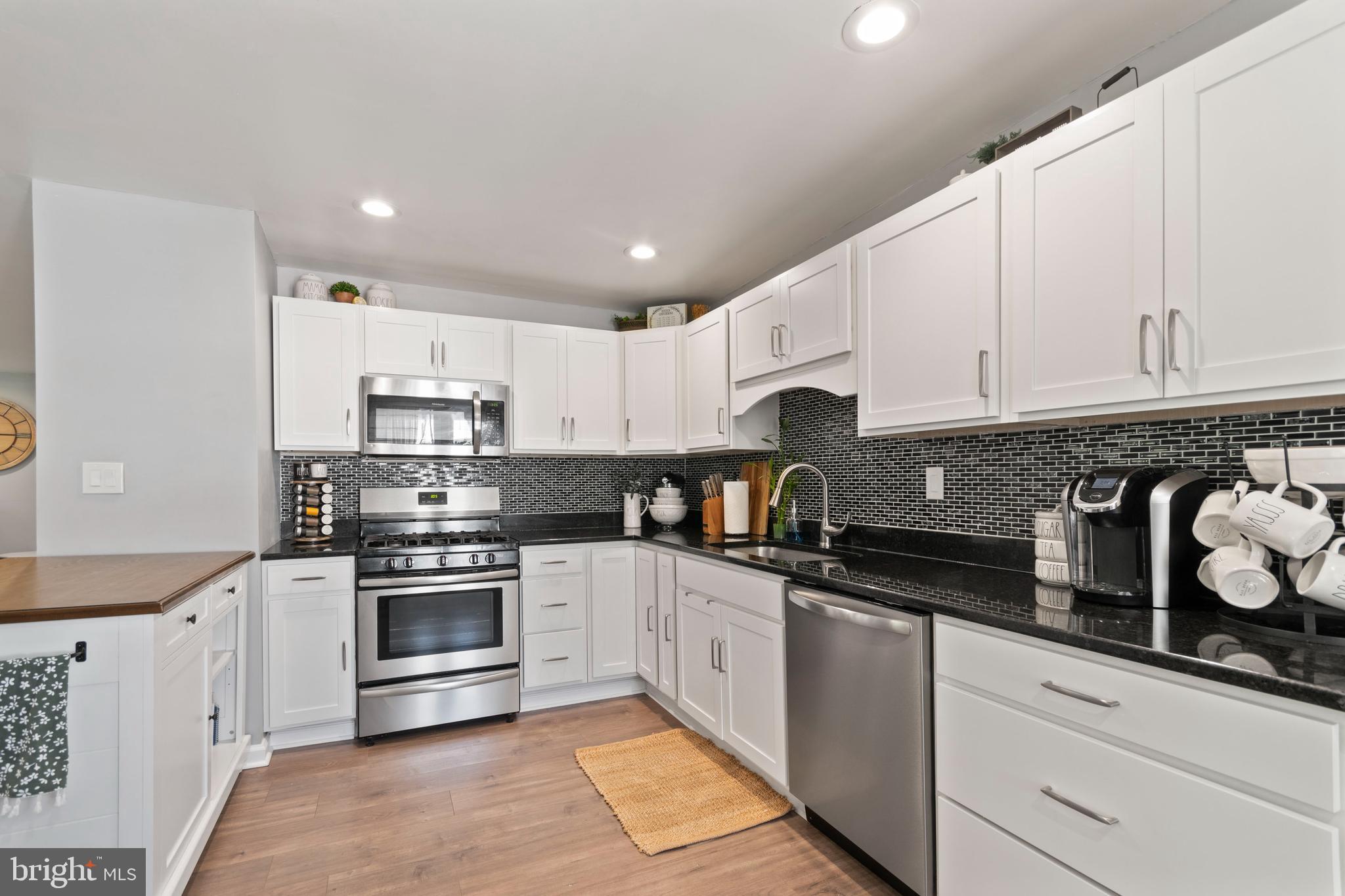 1 West Post Road Morrisville, PA 19067 - Photo 6 of 16 a kitchen with granite countertop white cabinets and stainless steel appliances