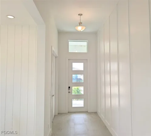 a kitchen with stainless steel appliances kitchen island granite countertop a sink a stove and a refrigerator