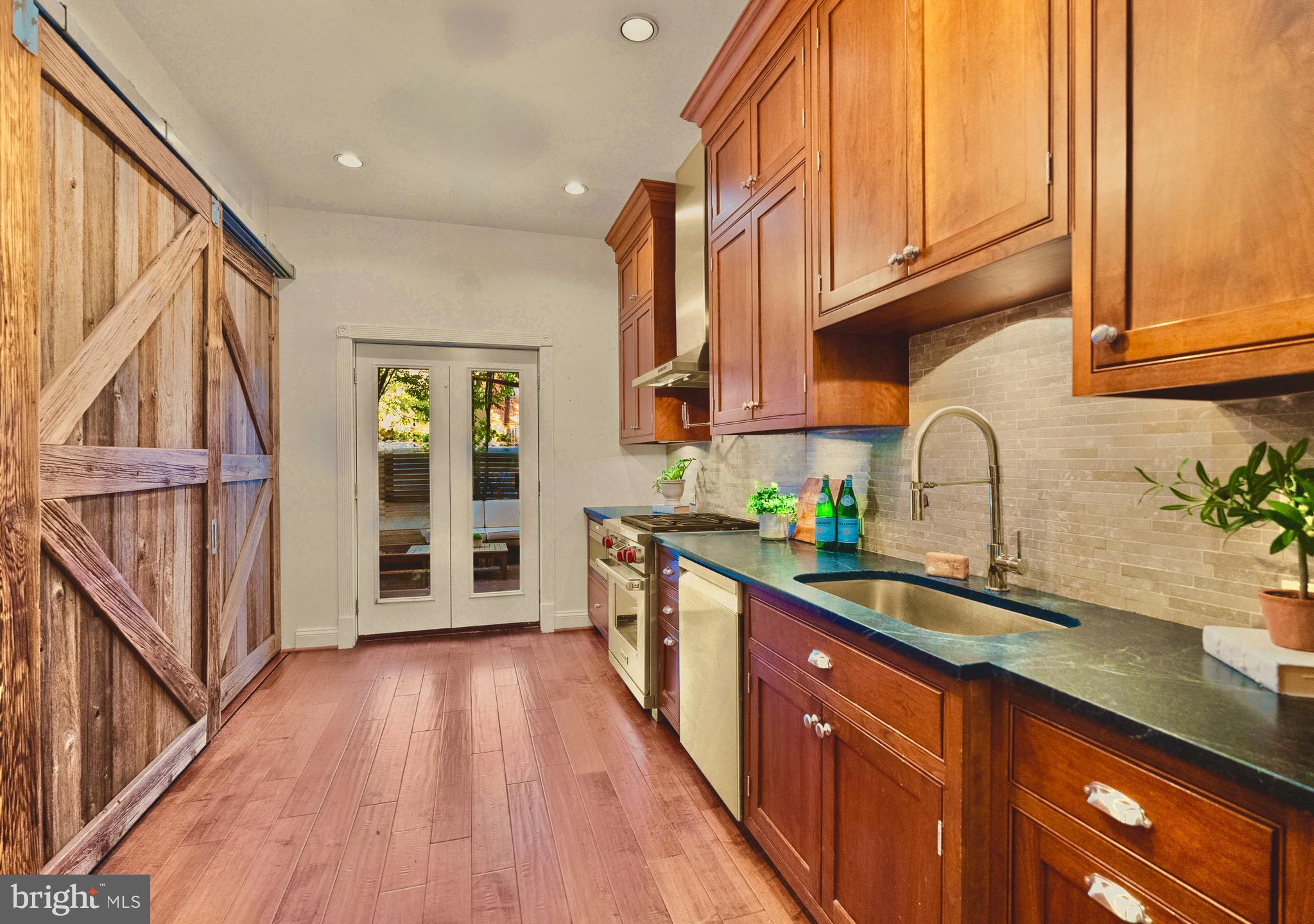 925 R Street Northwest Washington, DC 20001 - Photo 12 of 23 a kitchen with stainless steel appliances granite countertop a sink and wooden cabinets
