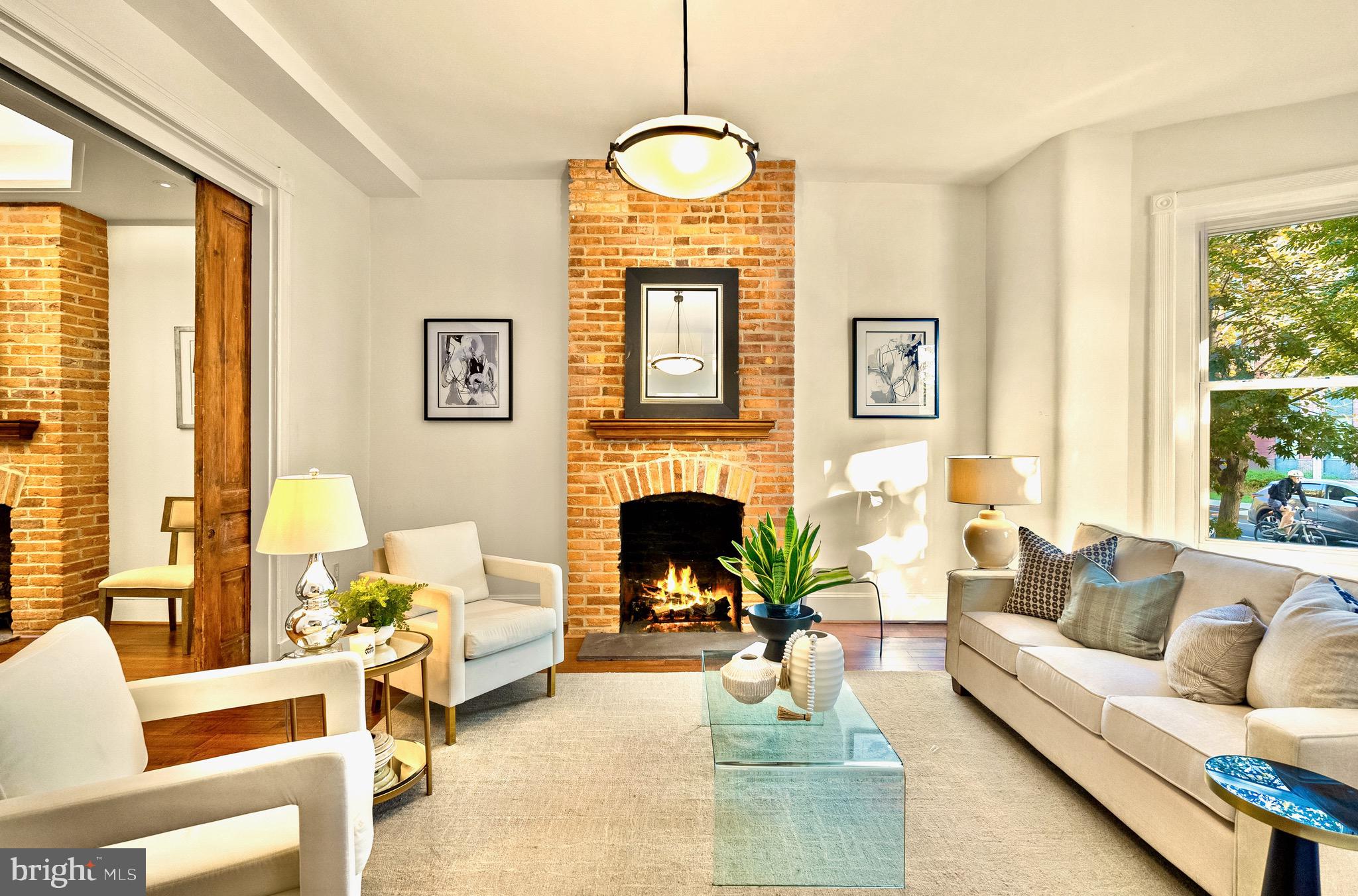 925 R Street Northwest Washington, DC 20001 - Photo 5 of 23 a living room with furniture a fireplace and a large window