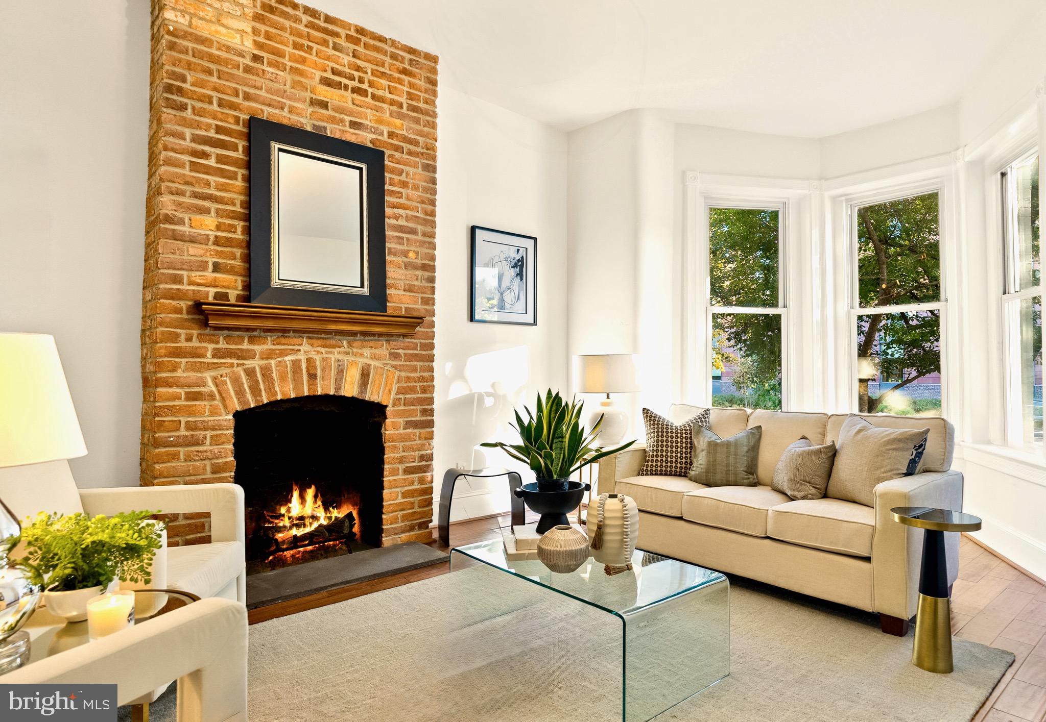 925 R Street Northwest Washington, DC 20001 - Photo 6 of 23 a living room with furniture a large window and a fireplace