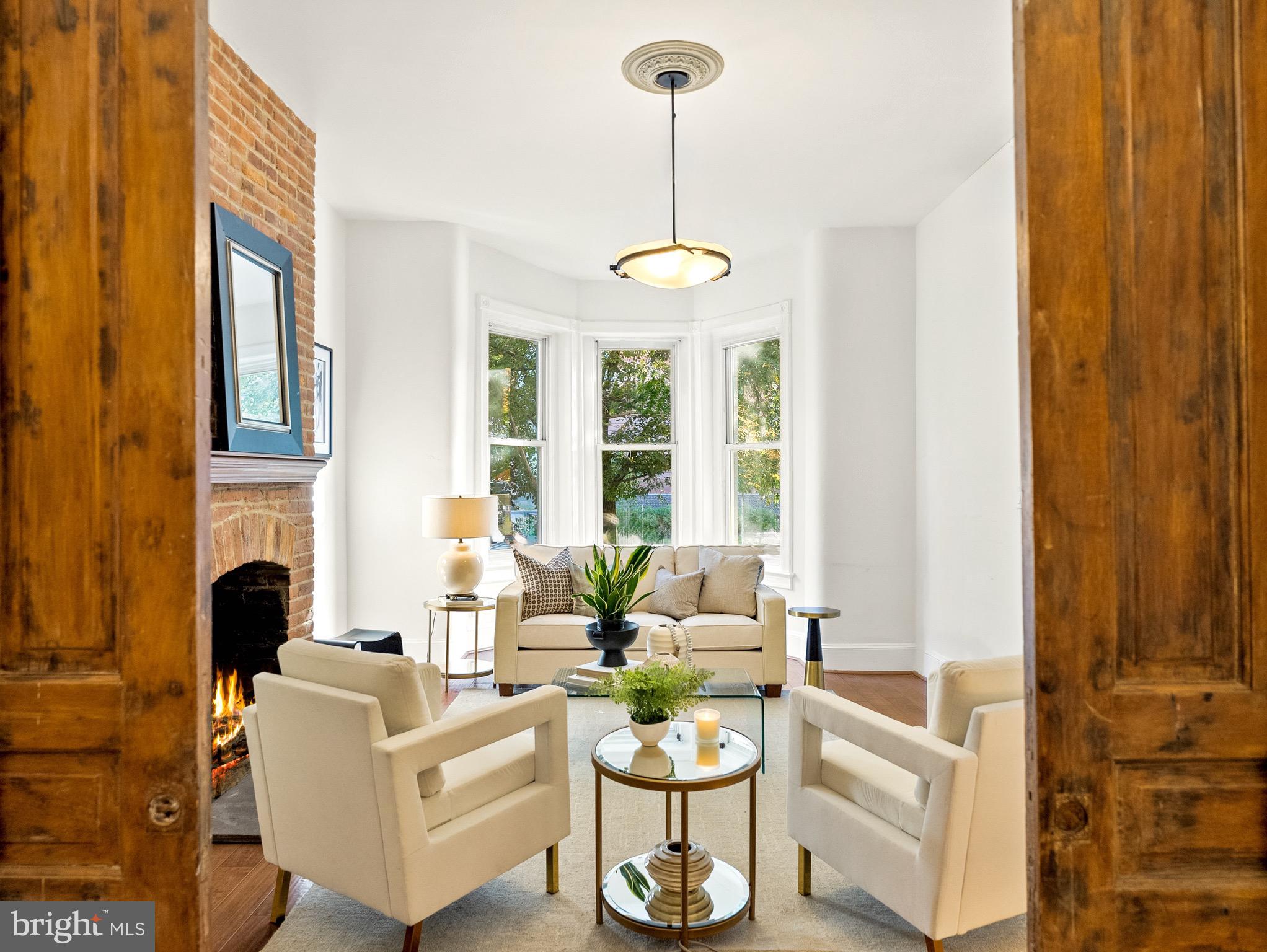925 R Street Northwest Washington, DC 20001 - Photo 8 of 23 a living room with fireplace furniture and a large window