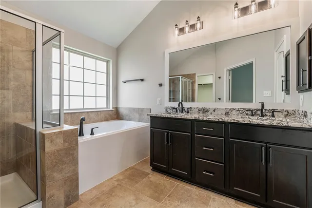 a bathroom with a tub sink and mirror