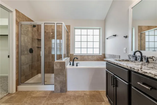 a bathroom with a granite countertop sink mirror and shower