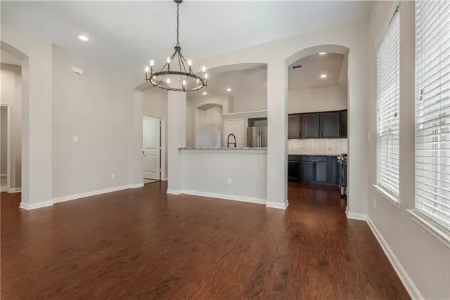 a view of a kitchen with a dishwasher cabinets and wooden floor