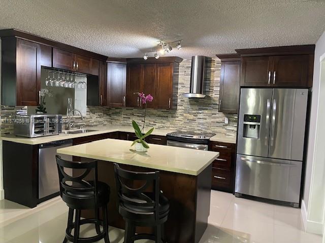 2701 Southwest 79th Avenue Miami, FL 33155 - Photo 11 of 53 a kitchen with kitchen island granite countertop wooden cabinets and refrigerator