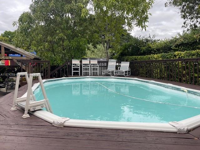 2701 Southwest 79th Avenue Miami, FL 33155 - Photo 22 of 53 a view of a swimming pool with a chair and tables