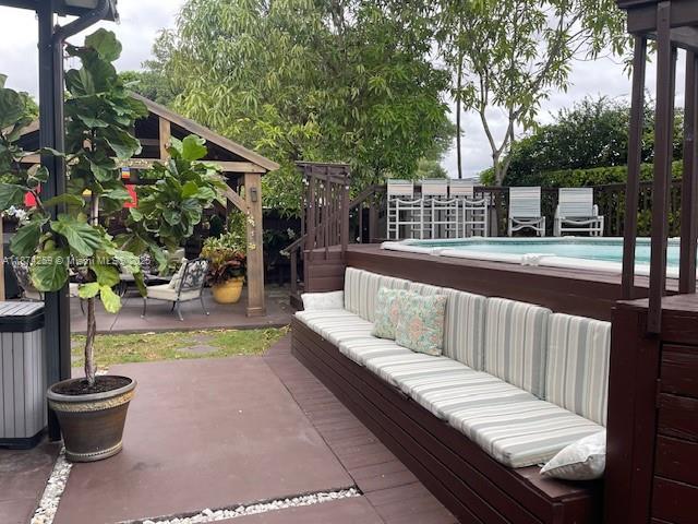 2701 Southwest 79th Avenue Miami, FL 33155 - Photo 25 of 53 a view of a two chairs and table in the patio with a fire pit