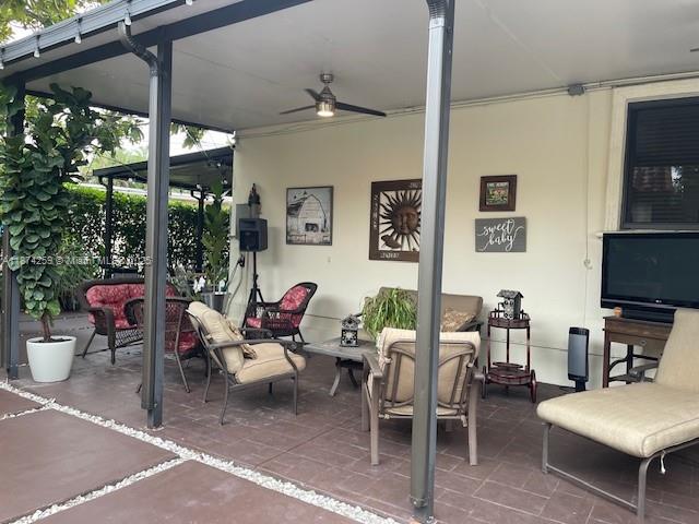 2701 Southwest 79th Avenue Miami, FL 33155 - Photo 30 of 53 a living room with furniture a flat screen tv and a floor to ceiling window