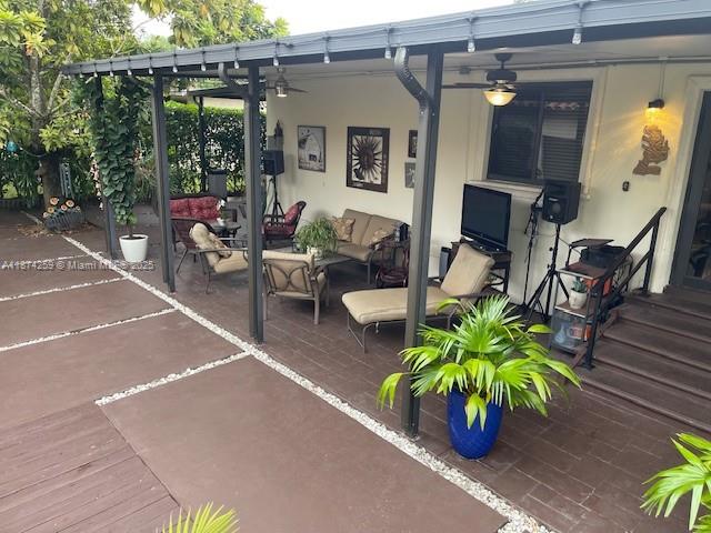2701 Southwest 79th Avenue Miami, FL 33155 - Photo 31 of 53 a view of a patio with table and chairs potted plants with wooden floor