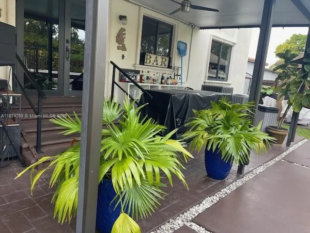 a view of a chair and table in backyard of the house