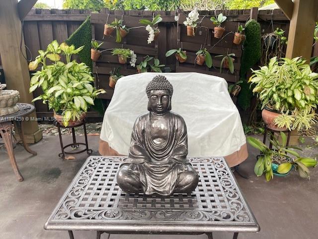 2701 Southwest 79th Avenue Miami, FL 33155 - Photo 49 of 53 a table with a vase and flowers on it