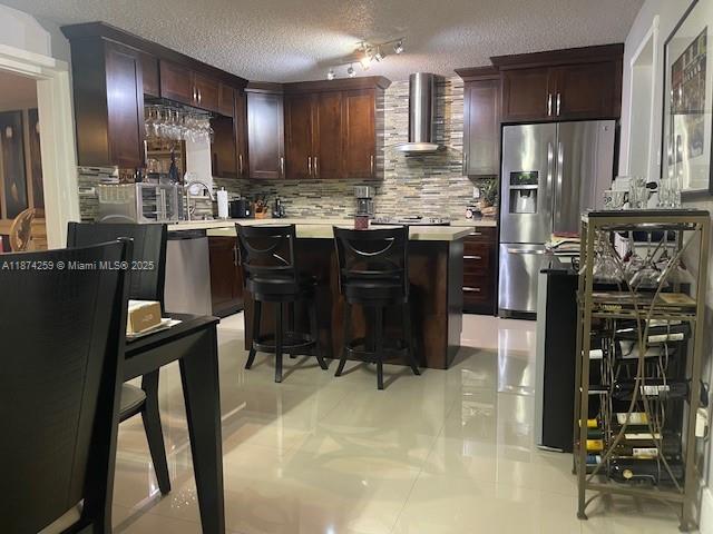2701 Southwest 79th Avenue Miami, FL 33155 - Photo 8 of 53 a kitchen with stainless steel appliances kitchen island granite countertop a refrigerator a stove a sink a dining table and chairs