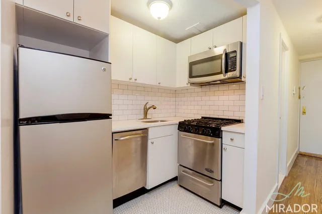a kitchen with a refrigerator stove and microwave