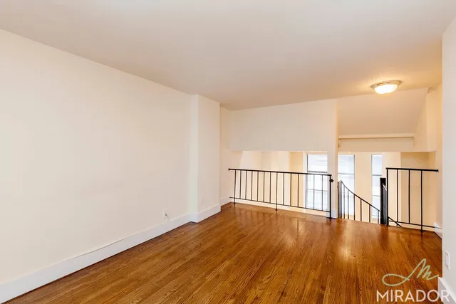 a view of a room with wooden floor