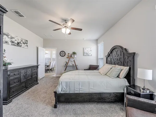 a bedroom with a bed and dresser