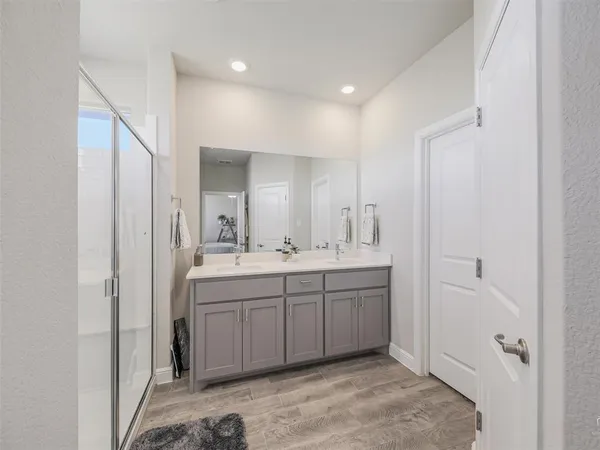 a spacious bathroom with a double vanity sink and a mirror