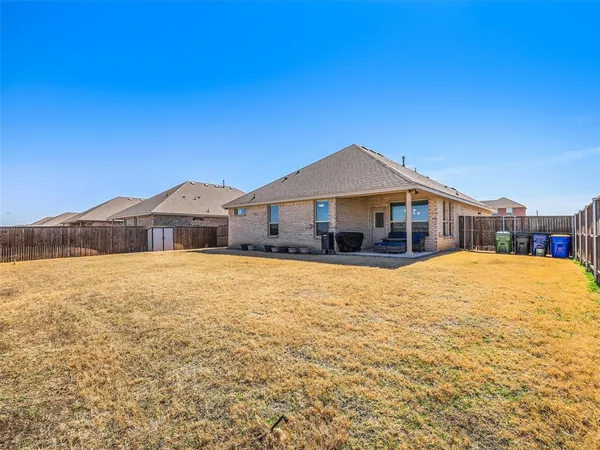 a blue swimming pool is in front of a house