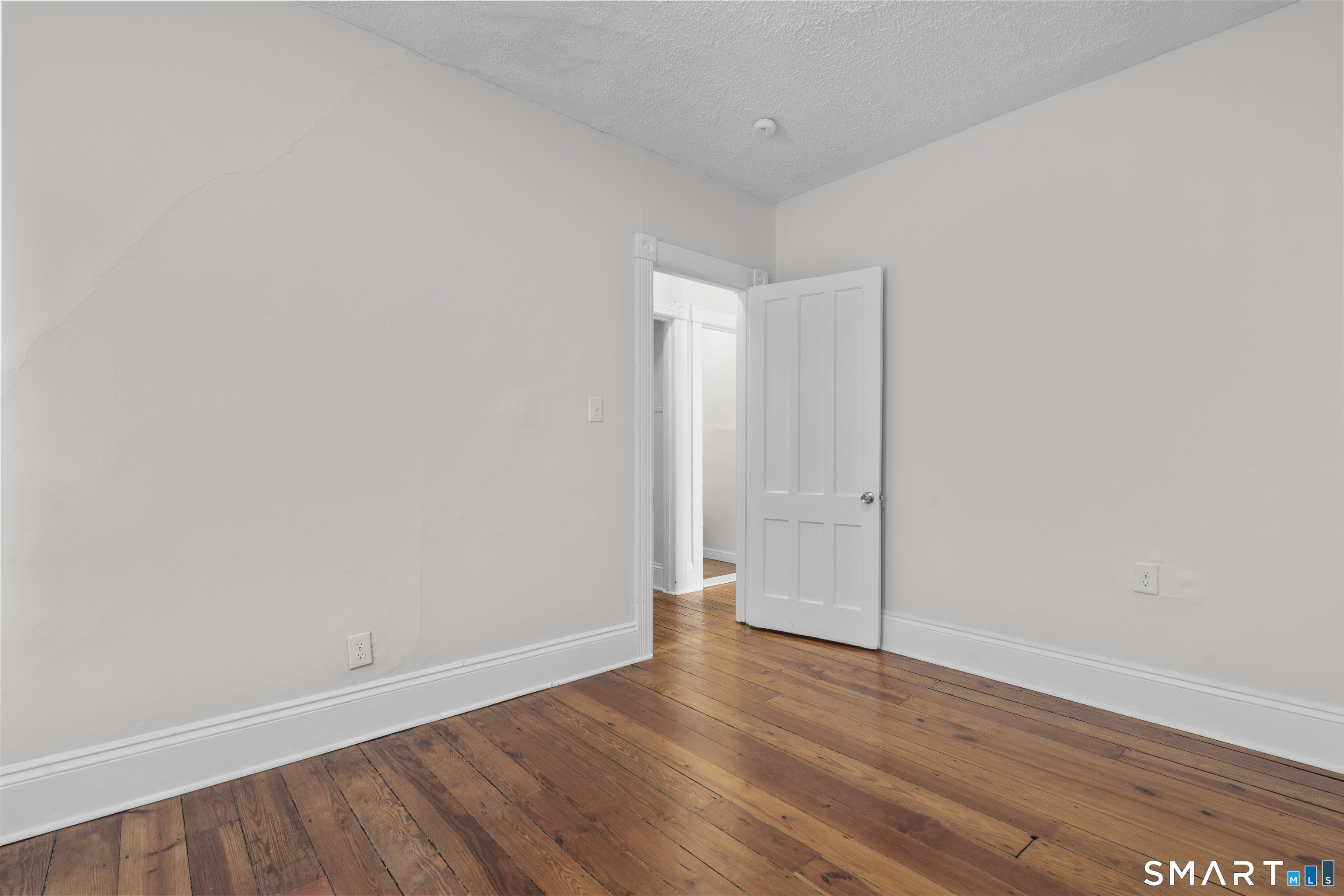 394 Gregory Street, Unit 1 Bridgeport, CT 06604 - Photo 11 of 23 a view of an empty room with wooden floor