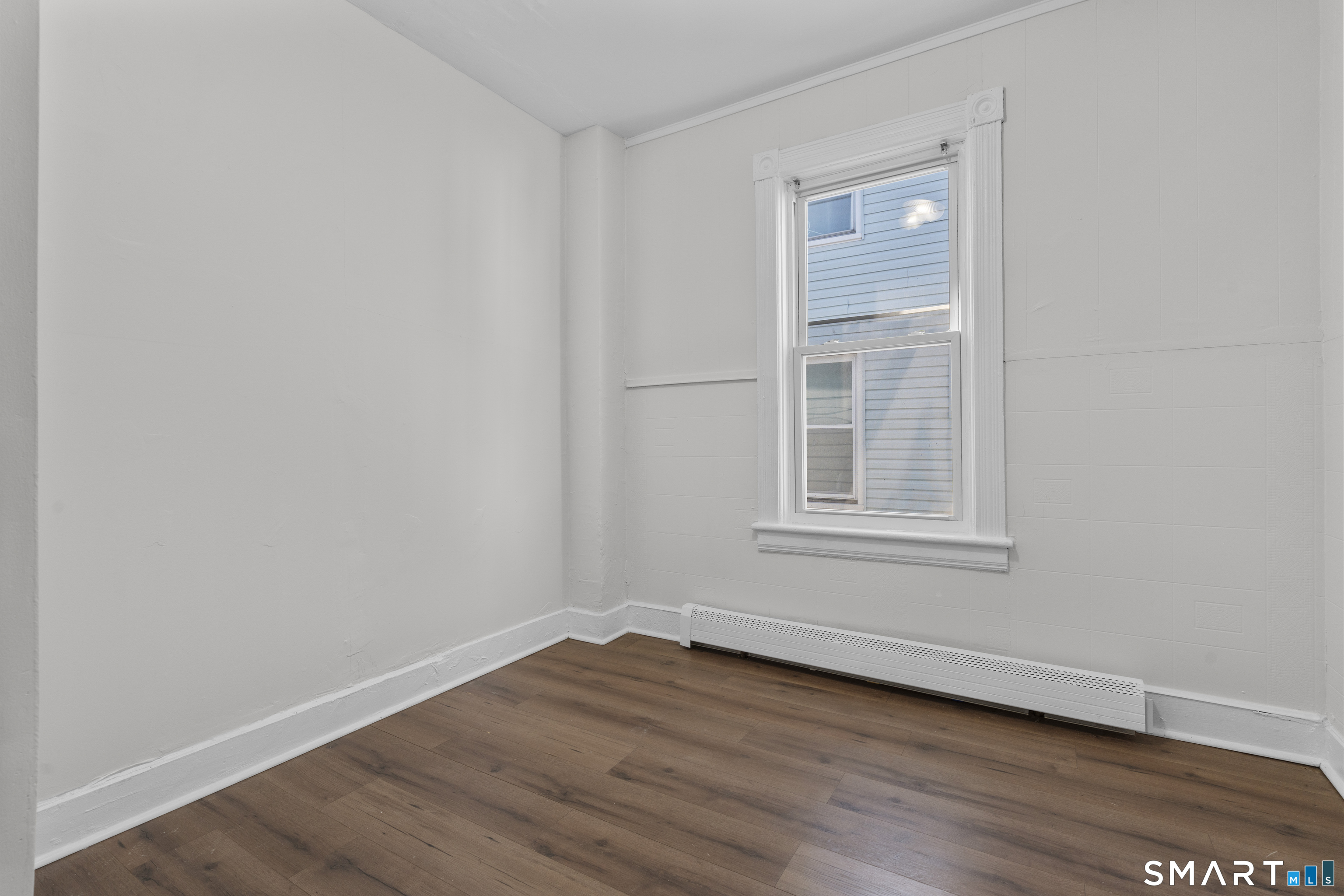 394 Gregory Street, Unit 1 Bridgeport, CT 06604 - Photo 16 of 23 a view of an empty room with wooden floor and a window