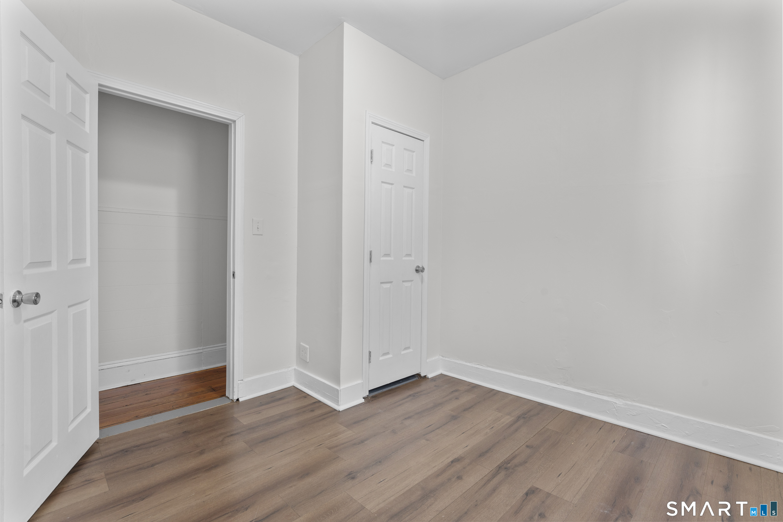 394 Gregory Street, Unit 1 Bridgeport, CT 06604 - Photo 17 of 23 a view of an empty room with wooden floor