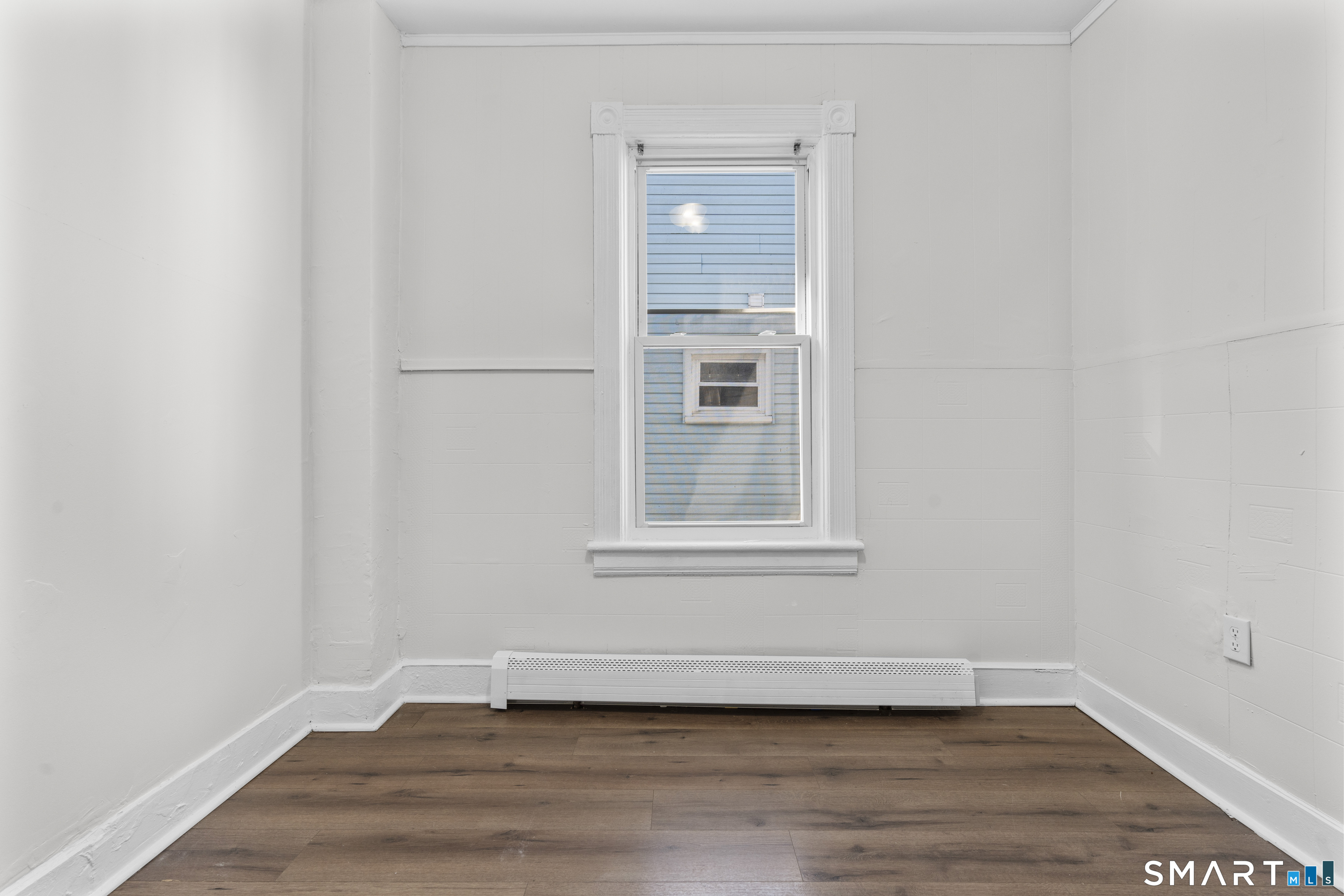 394 Gregory Street, Unit 1 Bridgeport, CT 06604 - Photo 18 of 23 a view of an empty room with wooden floor and a window