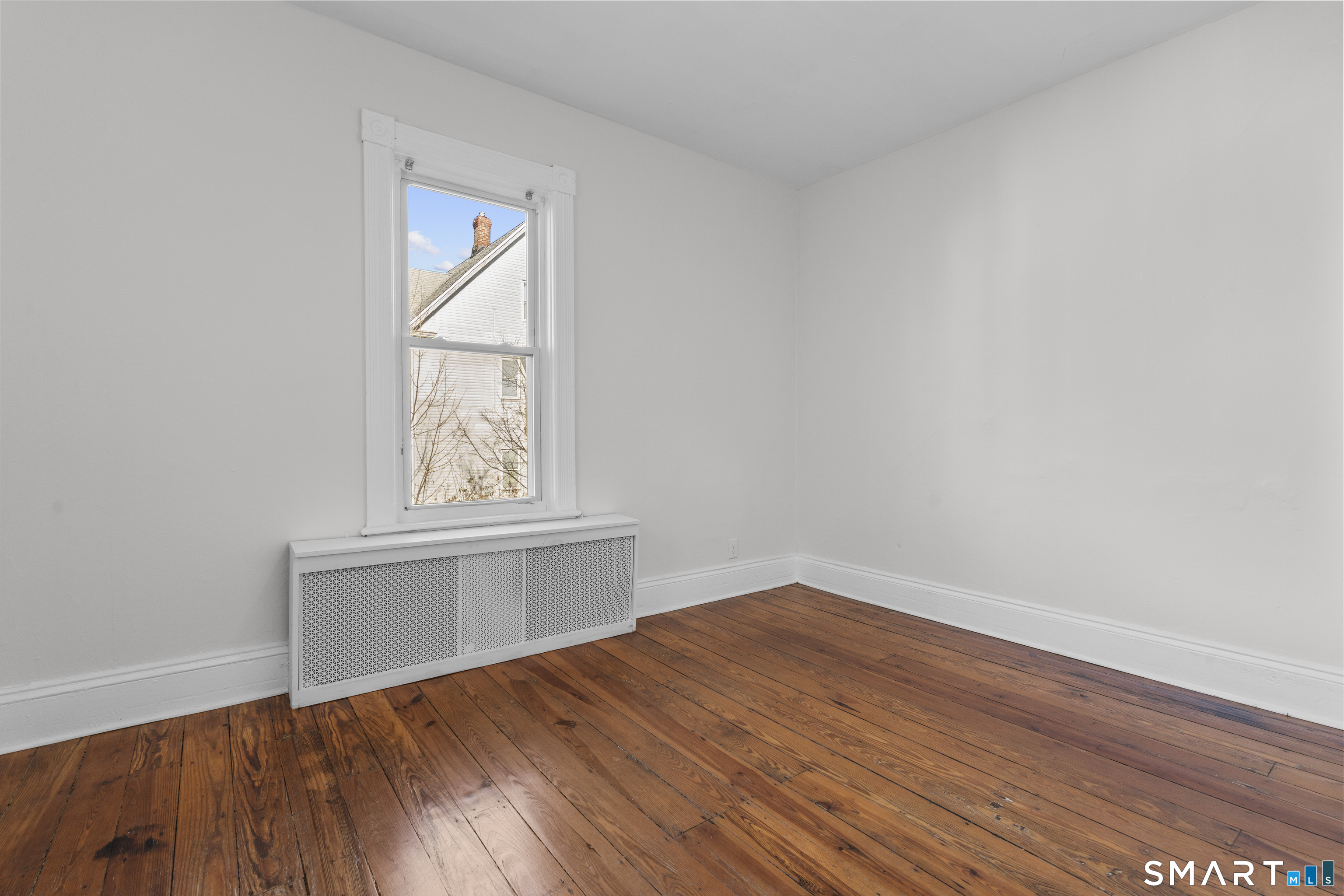 394 Gregory Street, Unit 1 Bridgeport, CT 06604 - Photo 19 of 23 an empty room with wooden floor and windows