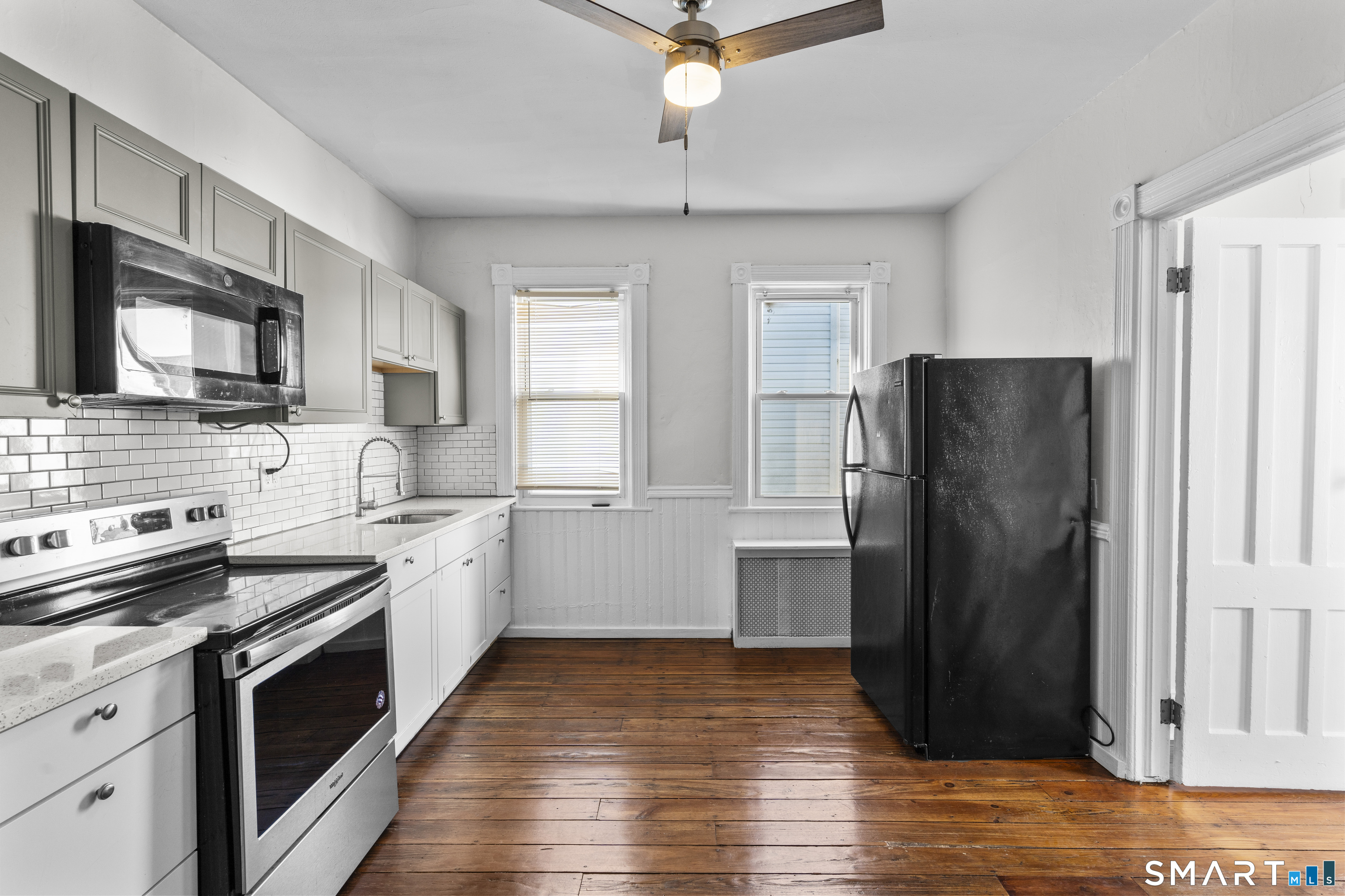 394 Gregory Street, Unit 1 Bridgeport, CT 06604 - Photo 2 of 23 a kitchen with a refrigerator stove and sink