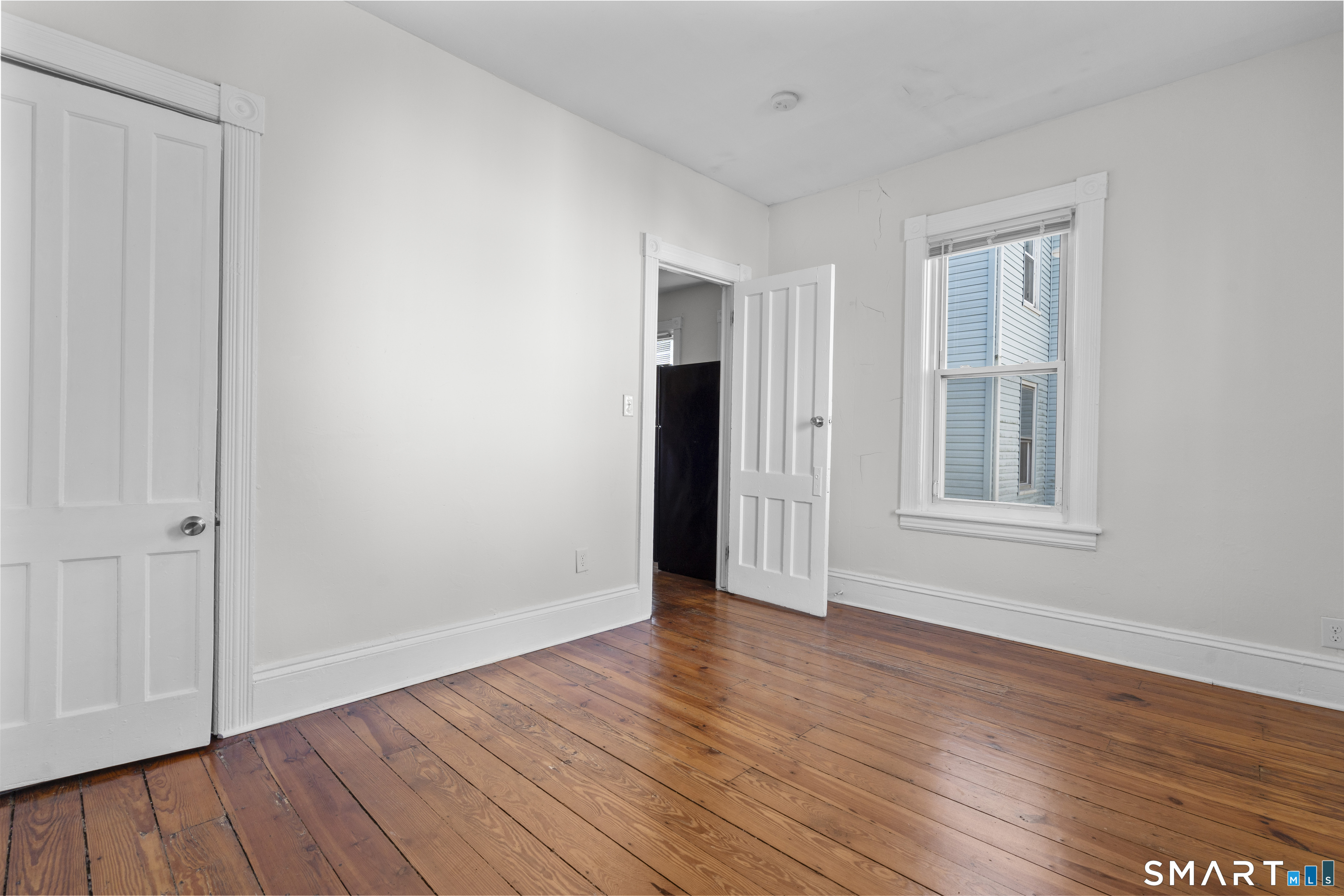 394 Gregory Street, Unit 1 Bridgeport, CT 06604 - Photo 21 of 23 a view of an empty room with wooden floor and a window