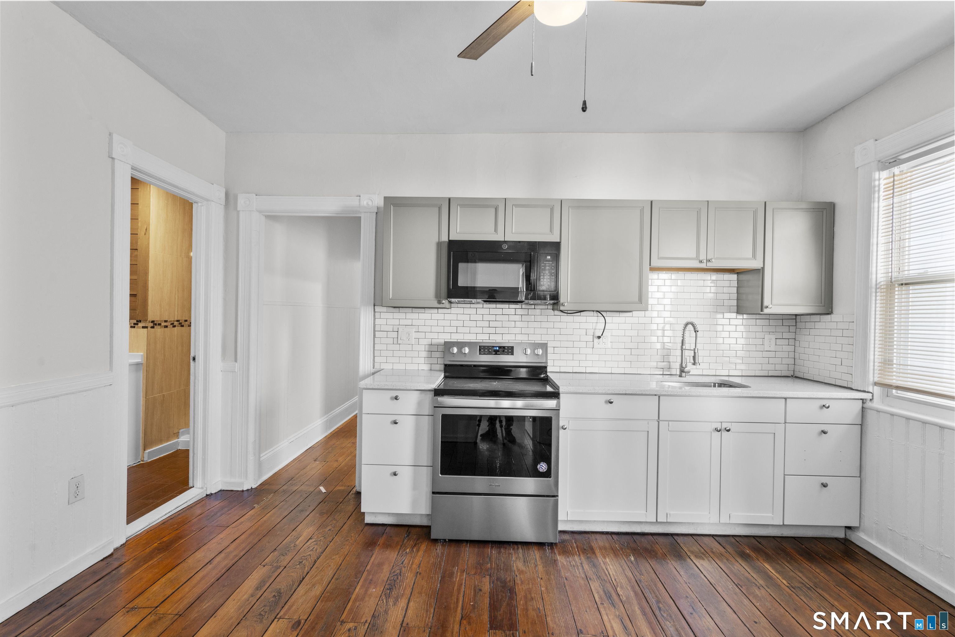 394 Gregory Street, Unit 1 Bridgeport, CT 06604 - Photo 4 of 23 a kitchen with stainless steel appliances a stove a sink and a microwave
