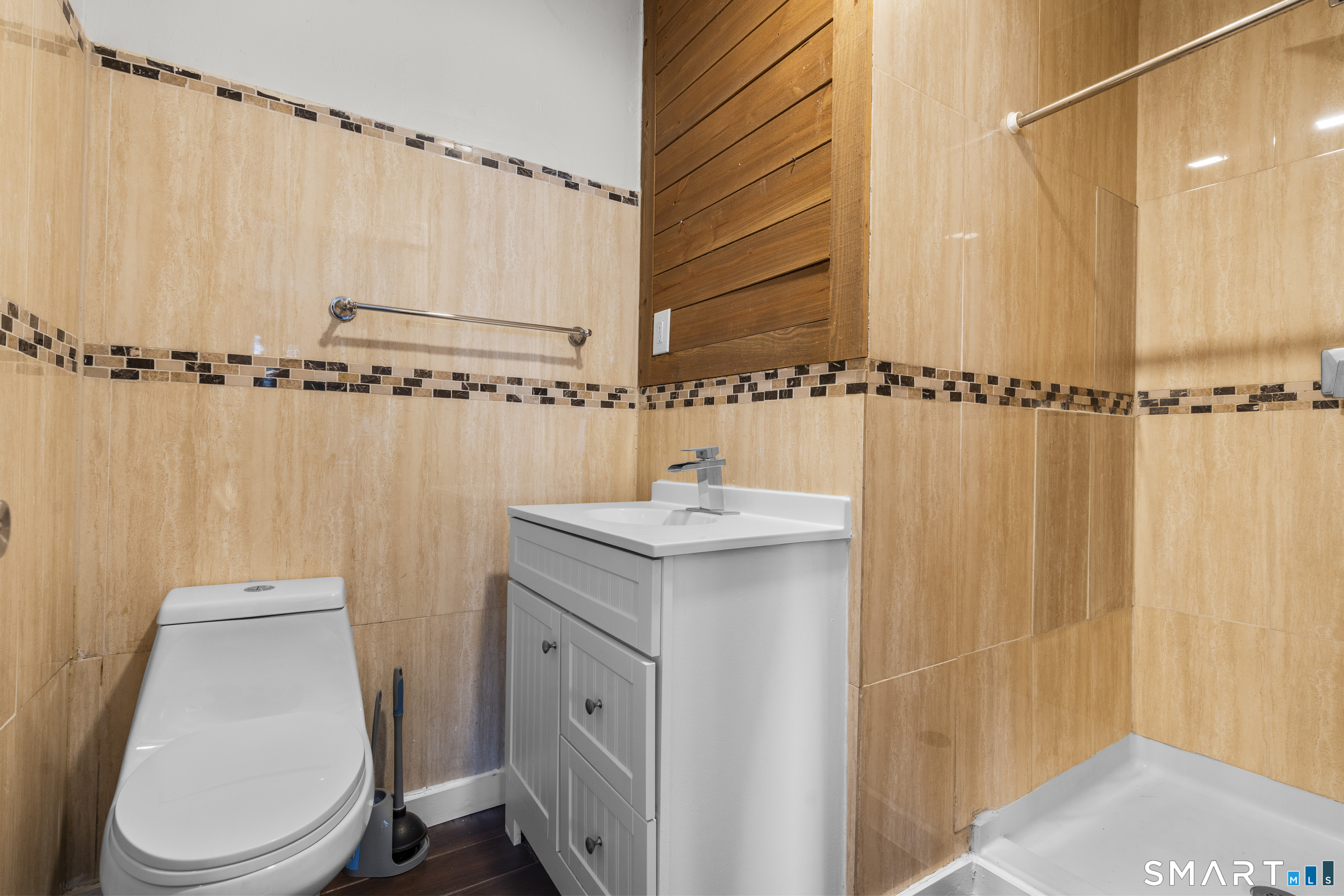 394 Gregory Street, Unit 1 Bridgeport, CT 06604 - Photo 7 of 23 a bathroom with a sink a toilet and shower