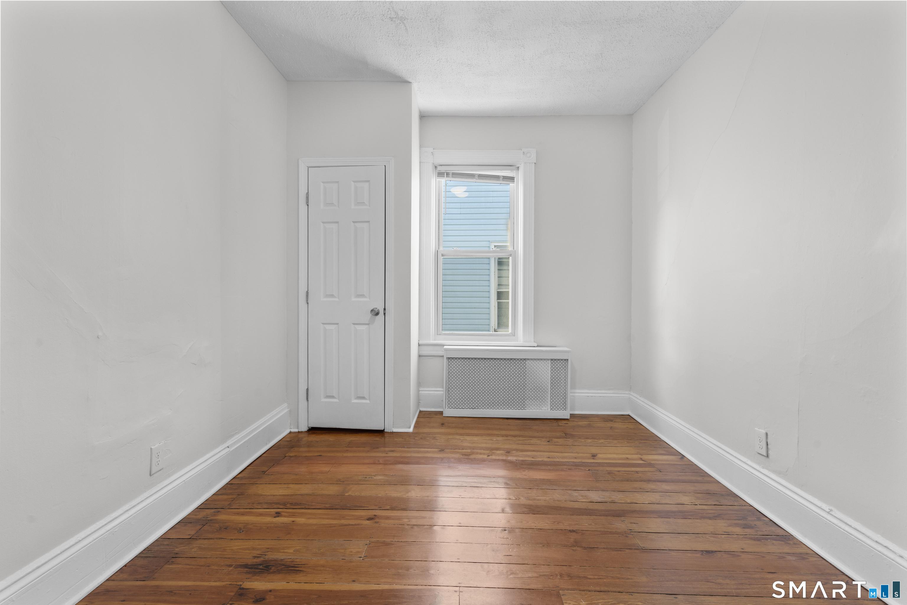 394 Gregory Street, Unit 1 Bridgeport, CT 06604 - Photo 10 of 23 a view of empty room with wooden floor and fan